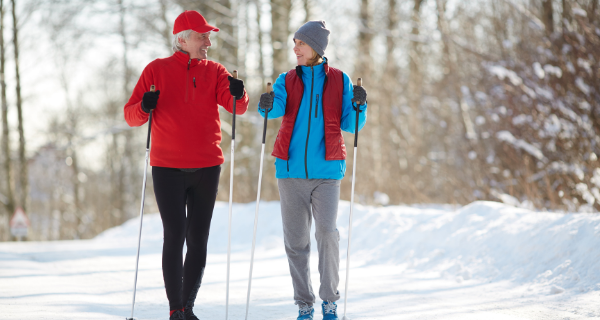 Senior couple cross country skiing together