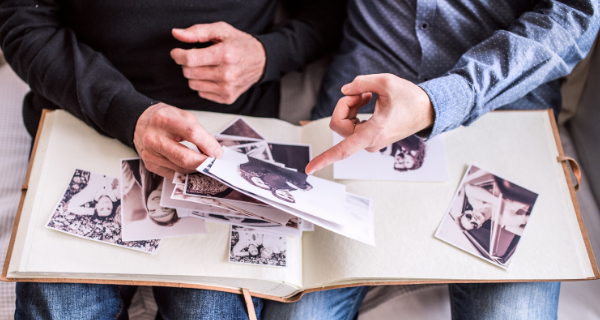 Senior in memory care at The Bristal Assisted Living looking at old photos with someone.