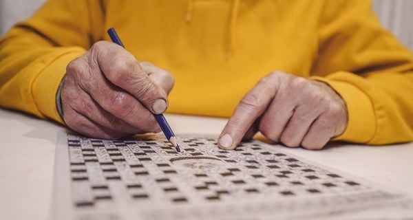 A person with dementia doing a crossword puzzle.