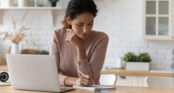 Woman planning her schedule to care for her senior parent and the rest of her weekly responsibilities and activities