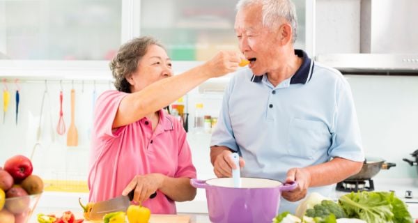 mature couple cooking a healthy meal together.