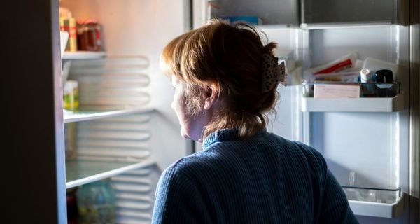 Woman with alzheimer’s going to the refrigerator for a late night snack.