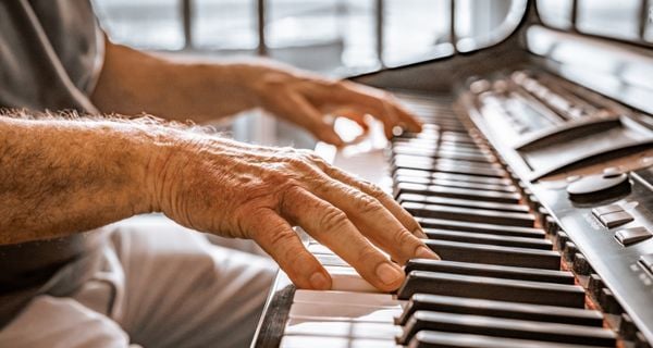 mature man learning to play the piano