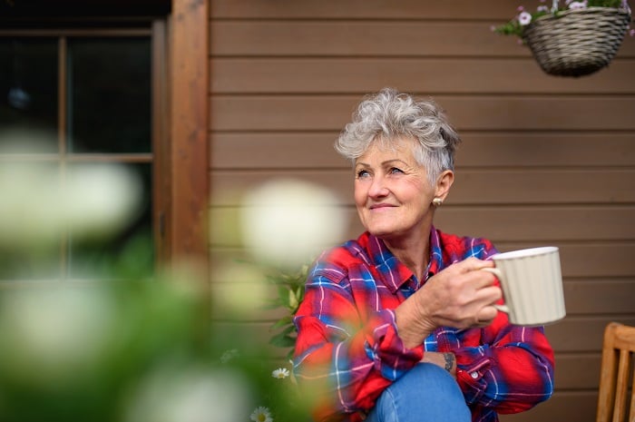 Senior woman enjoys coffee outdoors during morning routine