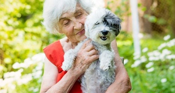 mature woman holding her dog
