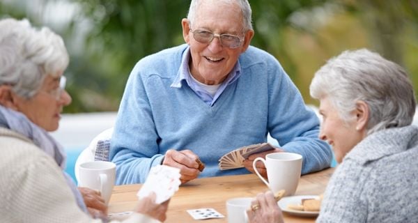 Mature friends playing cards