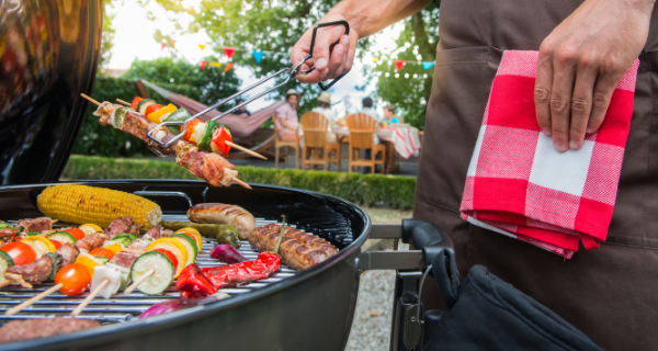 Various barbeque foods on a grill.