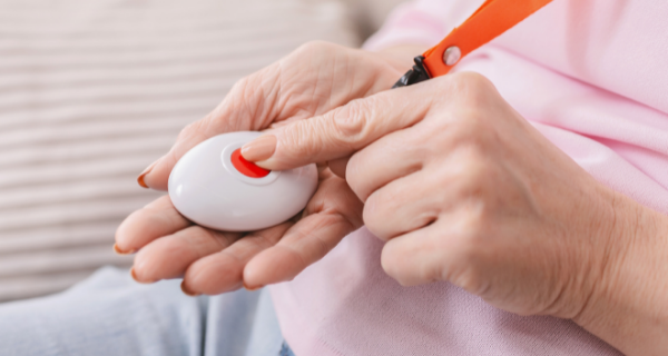 Senior wearing and using a safe response system in case they need help or get lost. 