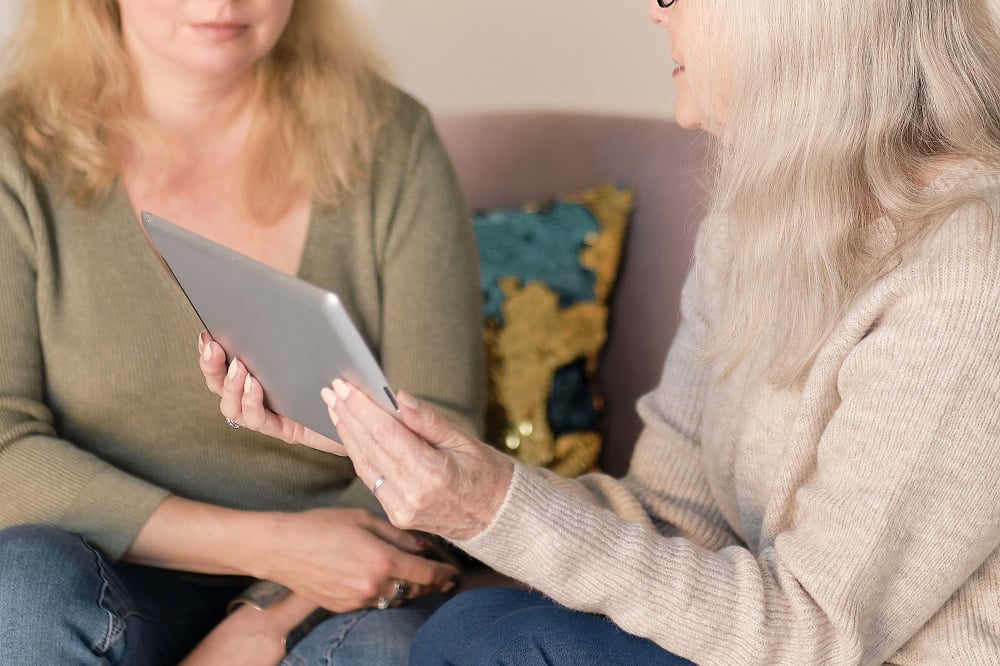 Caregiver helps woman with Alzheimer’s use tablet