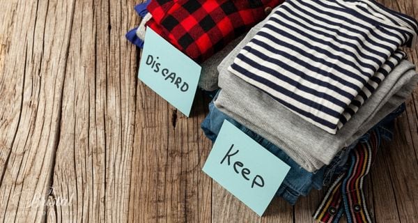 two piles of clothing labeled discard and keep