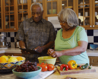 senior couple in kitchen preparing a healthy meal together
