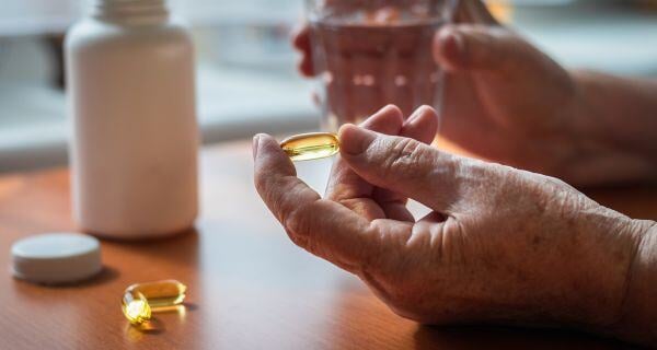 Mature man taking his vitamins.