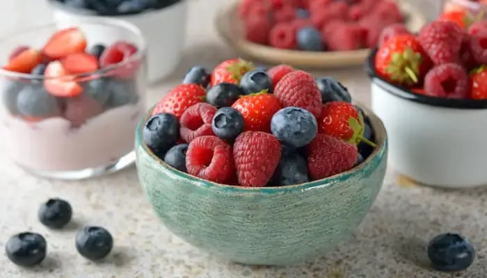 Bowls of berries and berries with yogurt