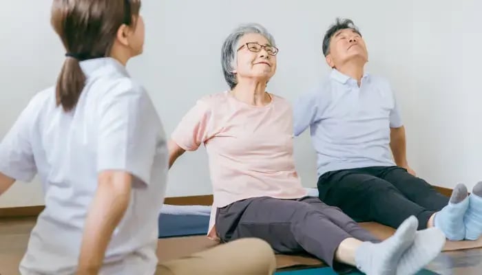 senior Asian woman practicing deep breathing exercises