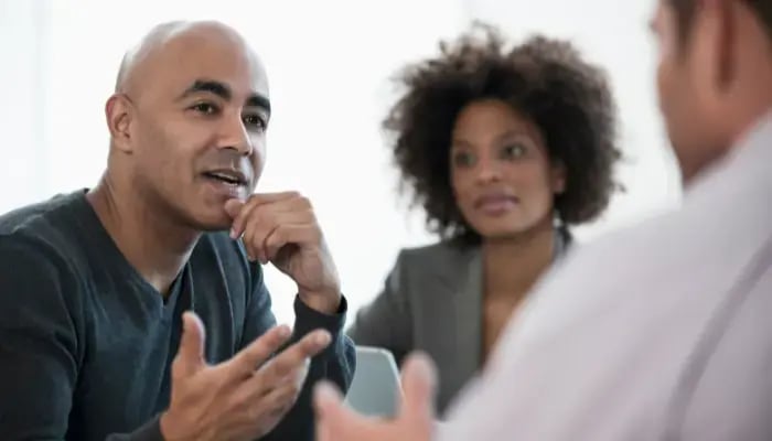 Adult child of a parent needing memory care talking with staff