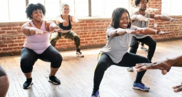 Dementia caregiver taking care of her physical health by attending a fitness class.