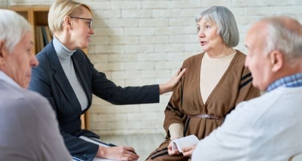 Dementia caregivers meeting with a support team.