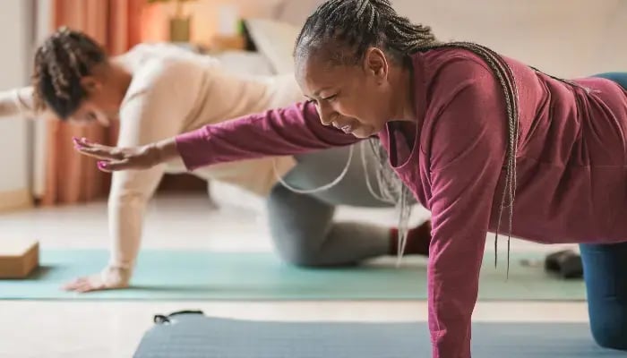 Senior African American woman practicing gentle exercises