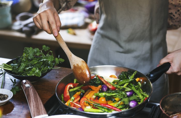 Woman’s hands cooking healthy vegetable dish 
