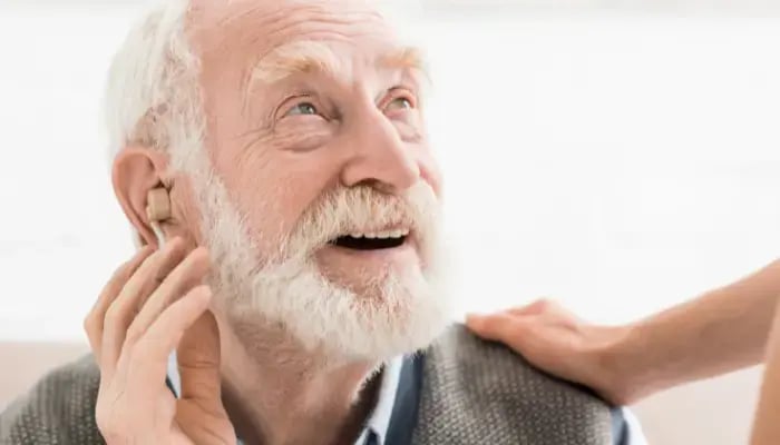 Mature man getting hearing aids