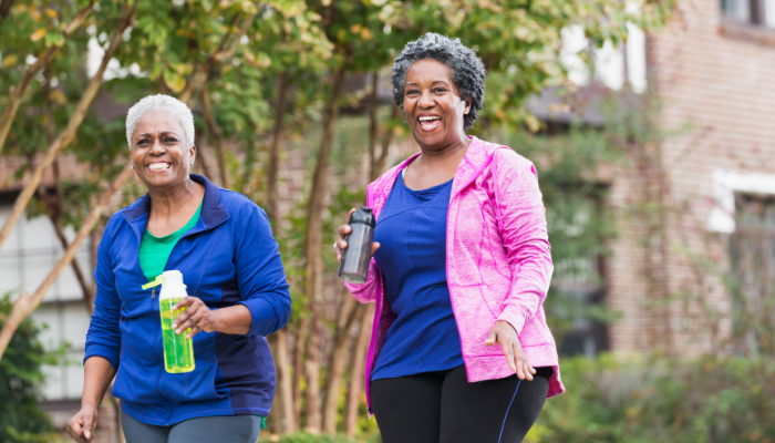 Two mature women going for a  walk in bright colors.