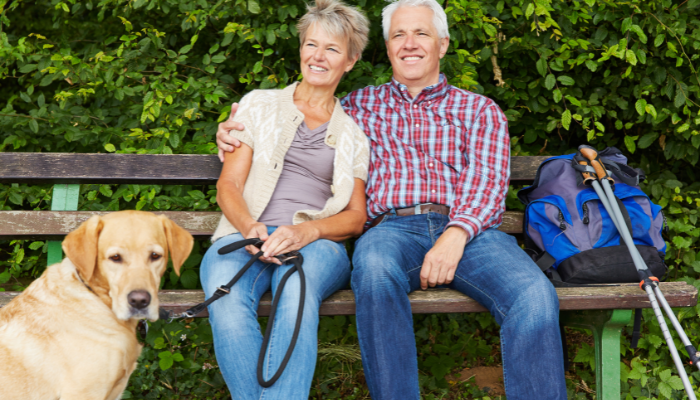 Senior couple taking a break on a bench. 