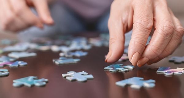 Mature people putting a puzzle together.