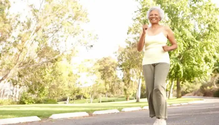 Senior woman walks outdoors in park setting