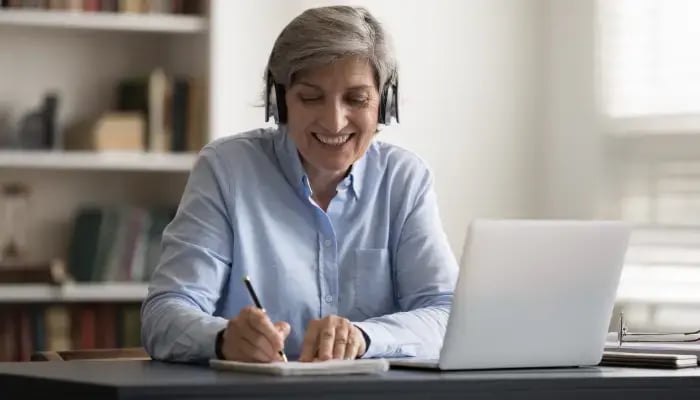 Mature woman taking online lessons to learn a new language
