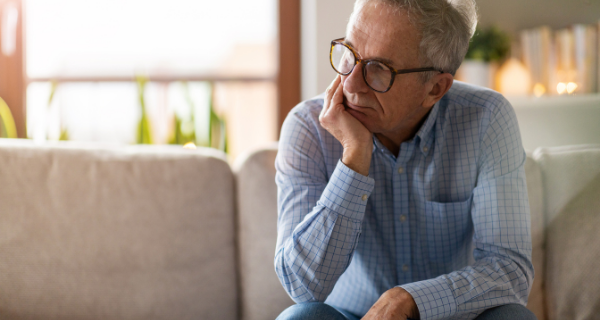 Senior man experiencing low energy and dementia fatigue.