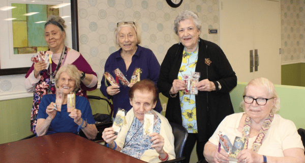Lynbrook residents of The Bristal Assisted Living enjoying the World of Flowers Immersive Experience