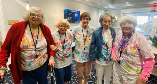 senior women posing in their tie dye shirts
