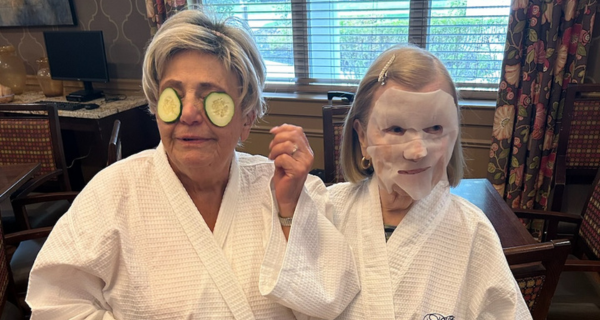 senior women with facemask and cucumbers on eyes 