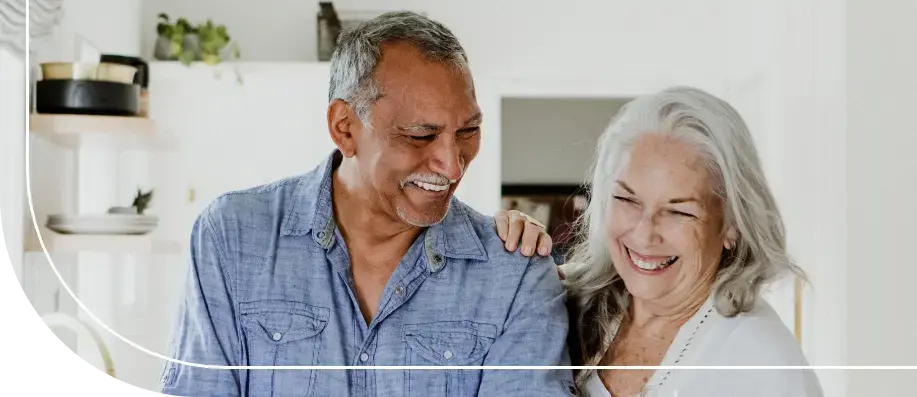 Senior couple laughing together in the kitchen