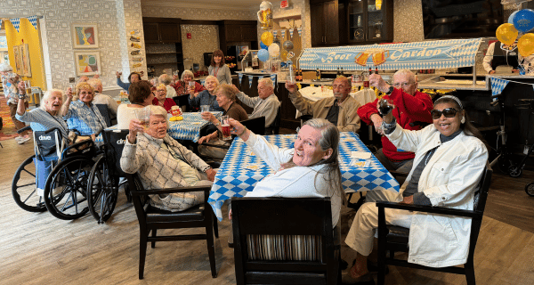 Residents of The Bristal at Wayne raise their beer glasses in a toast of friendship!