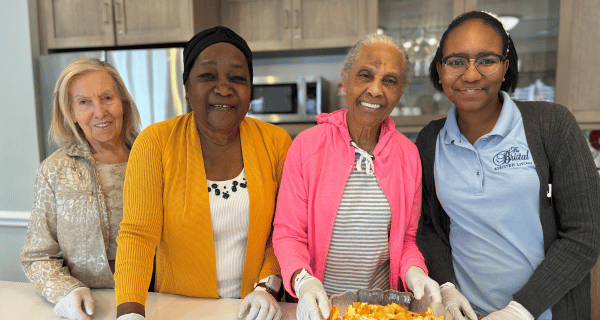 Seniors living in Reflections at The Bristal at North Woodmere prepare fruit salad for peers.