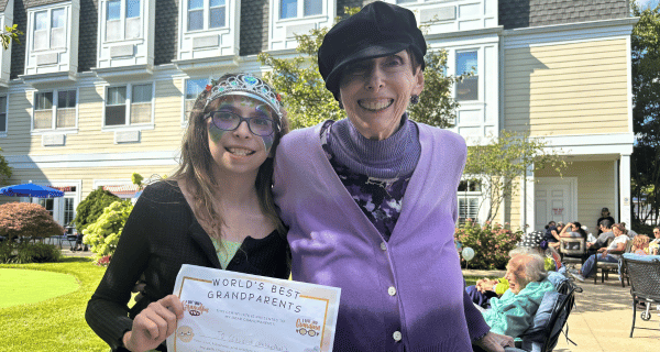 A resident of The Bristal at North Woodmere poses with her granddaughter during the Grandparents Day carnival.