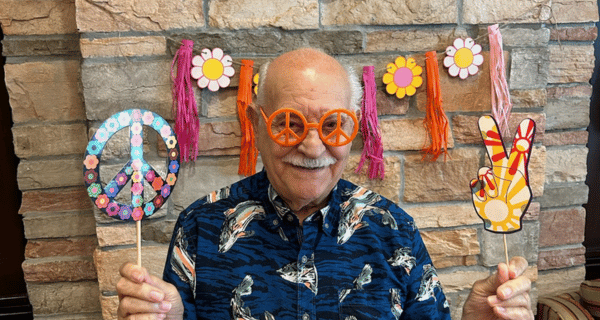 Lake Grove Resident gets into the groovy, hippie day wearing peace sign glasses.