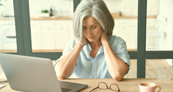 Tired caregiver in front of computer
