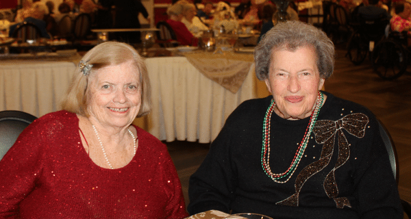 senior women seated at dinner table