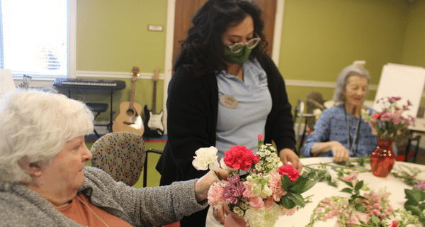 senior women working on bouquet