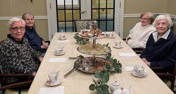 a group of seniors enjoying a tea party