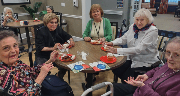 group of senior women enjoying cupcakes