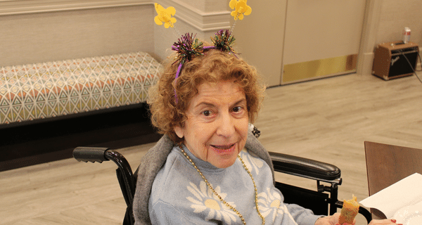 senior woman wearing mardi gras headband
