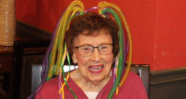 senior woman wearing mardi gras headband