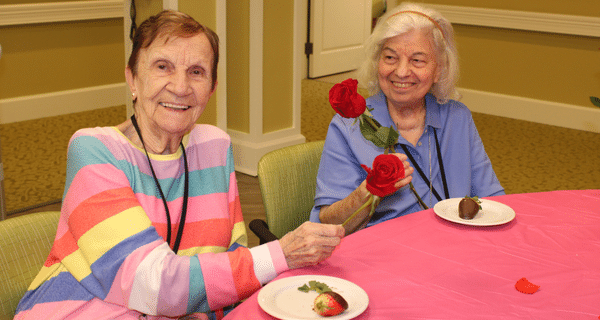 senior women holding roses