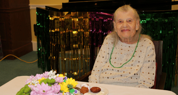 senior woman seated at table smiling