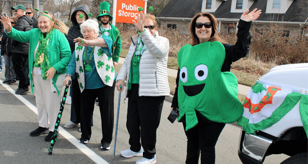 group of seniors and team members participating in St. Patrick's Day parade