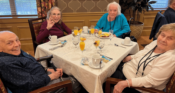 group of seniors seated at table enjoying brunch