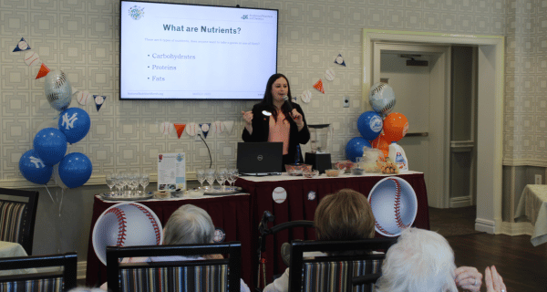 Dietician discussing nutrition with group of seniors